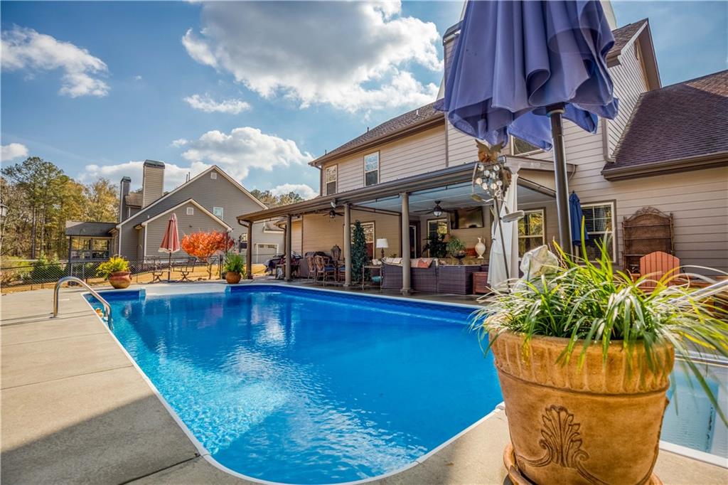1461 Bradford Lane Monroe, GA 30656 - Photo 52 of 66 a view of a swimming pool with potted plants