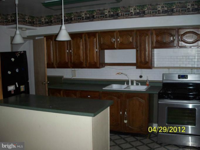 8052 Kimberly Road Dundalk, MD 21222 - Photo 2 of 6 a kitchen with a sink and cabinets