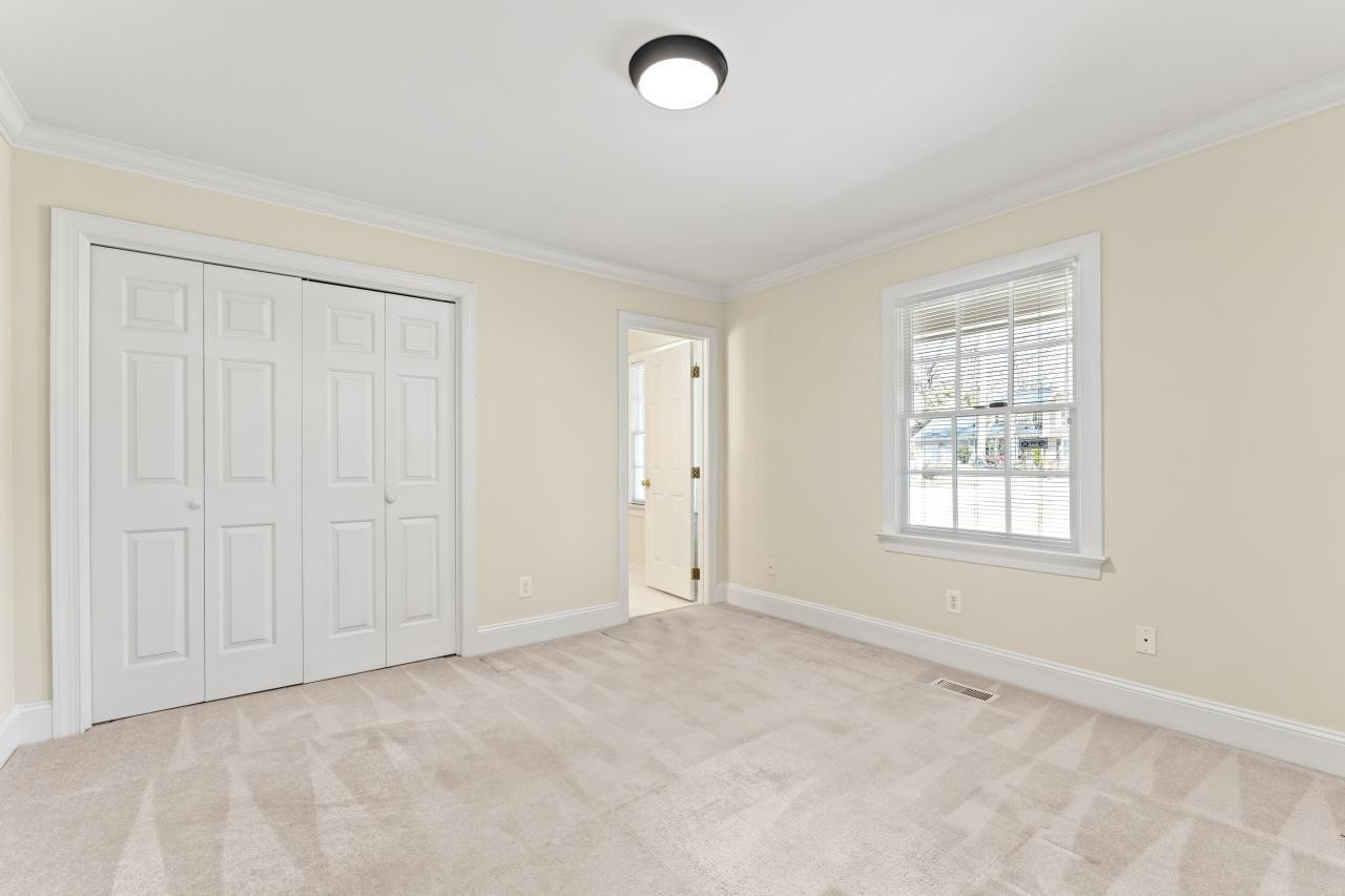 5013 Trail Ridge Drive Raleigh, NC 27613 - Photo 16 of 32 This main floor bedroom offers and attached bath. It has many uses - guest space, office, home gym, play room, homeschool room, you decide! 4th bedroom