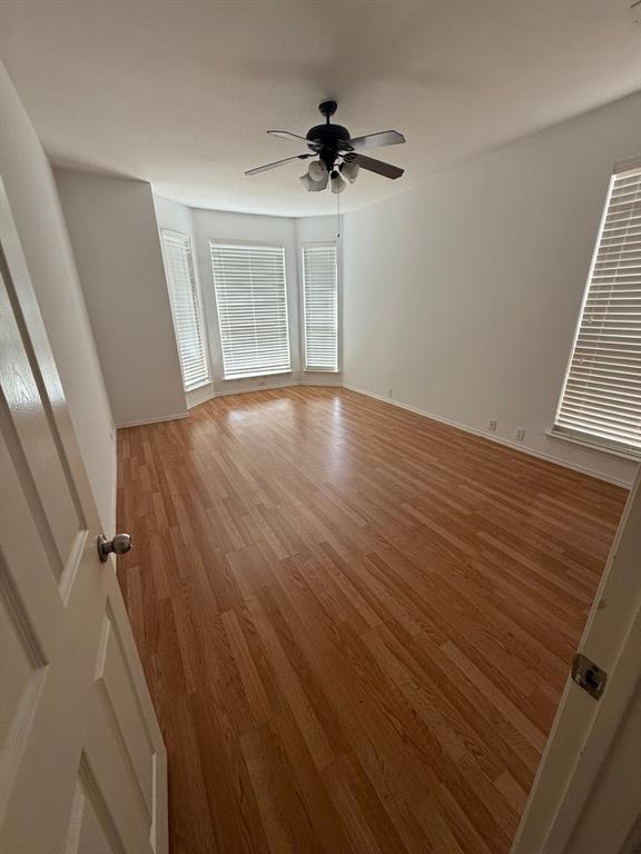 4620 Matthew Drive Fort Worth, TX 76244 - Photo 6 of 12 wooden floor in an empty room with a window