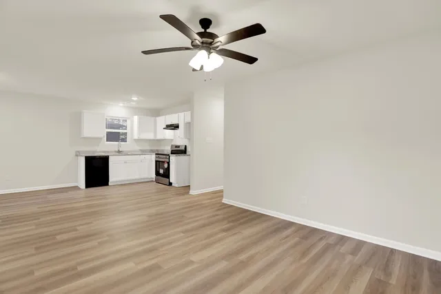 a view of kitchen with microwave and white cabinets