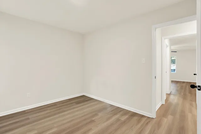 a view of a room with wooden floor