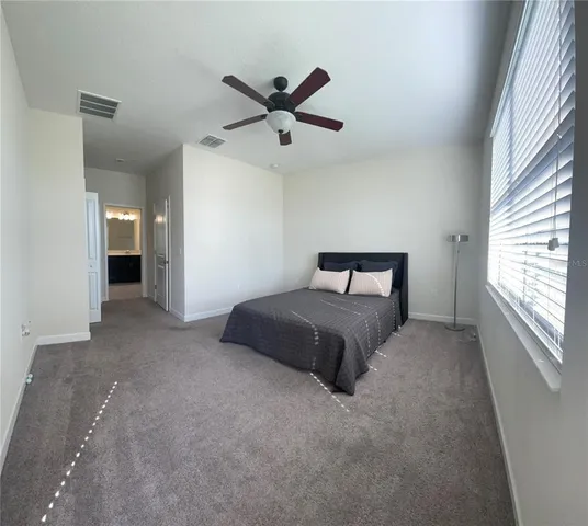 a bedroom with a bed and window