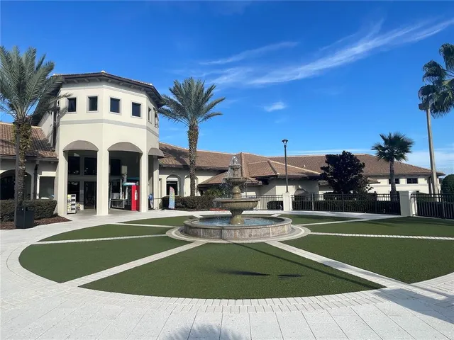 a front view of a building with cars parked