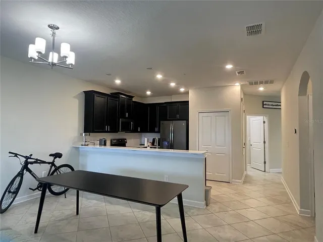 a large kitchen with a table and chairs