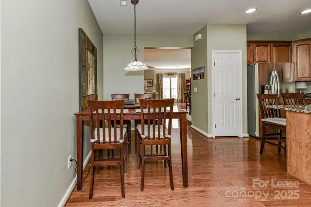 a view of a a dining room with furniture window and wooden floor