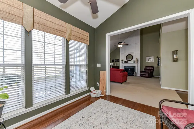 a bedroom with furniture and a large window