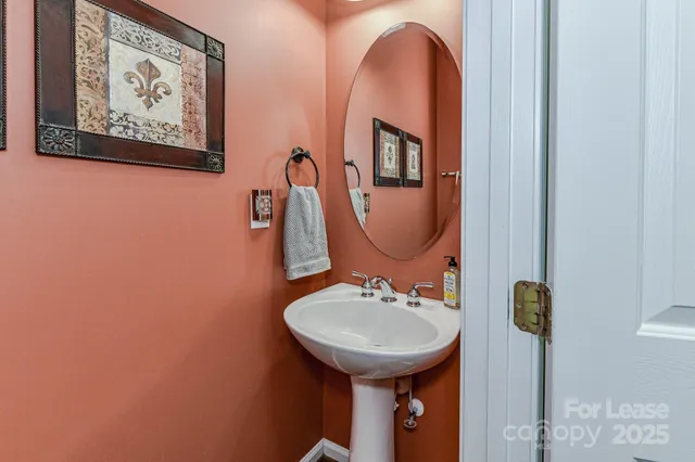 a bathroom with a sink mirror and toilet