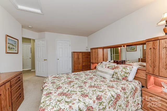 a bedroom with a large bed and a window