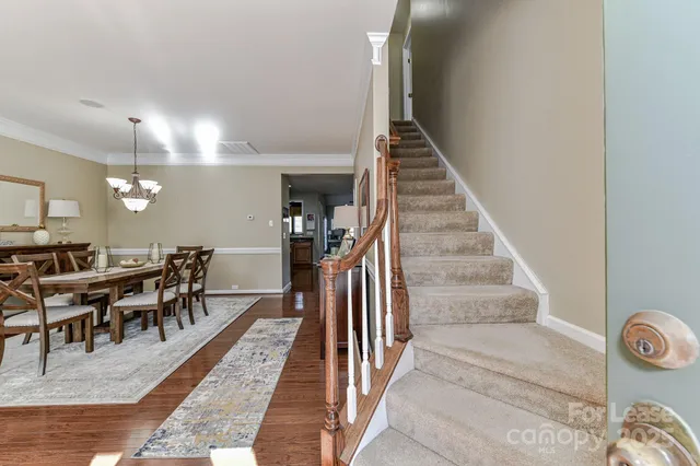 an entryway with wooden floor and livingroom view