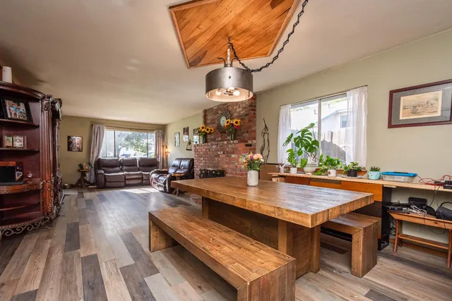 a bedroom with a bed a flat screen tv and a window