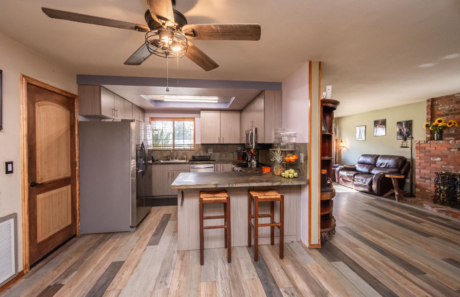 2266 River Trails Circle Rancho Cordova, CA 95670 - Photo 21 of 86 a kitchen with stainless steel appliances a dining table chairs refrigerator and cabinets