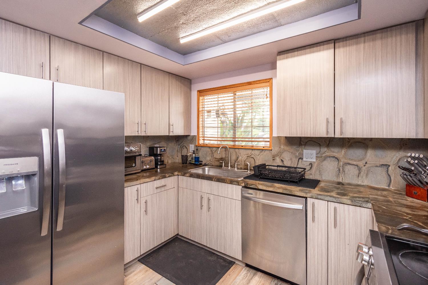 2266 River Trails Circle Rancho Cordova, CA 95670 - Photo 25 of 86 a kitchen with granite countertop a sink stainless steel appliances and cabinets