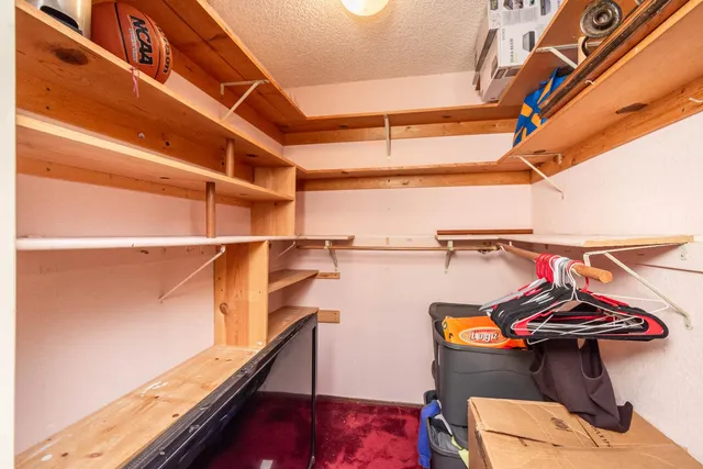 an aerial view of a house with a garden and lake view