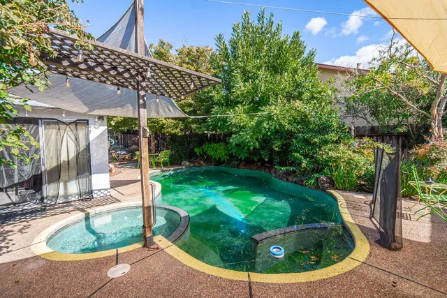 a view of a house with backyard sitting area and garden
