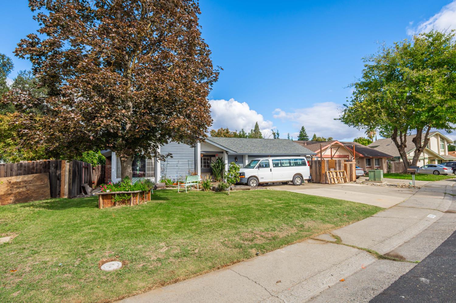 2266 River Trails Circle Rancho Cordova, CA 95670 - Photo 60 of 86 a front view of a house with a garden and trees