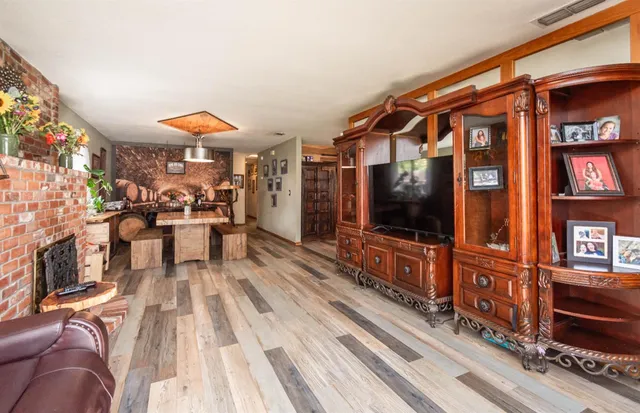 a view of a dining room with furniture a chandelier and wooden floor