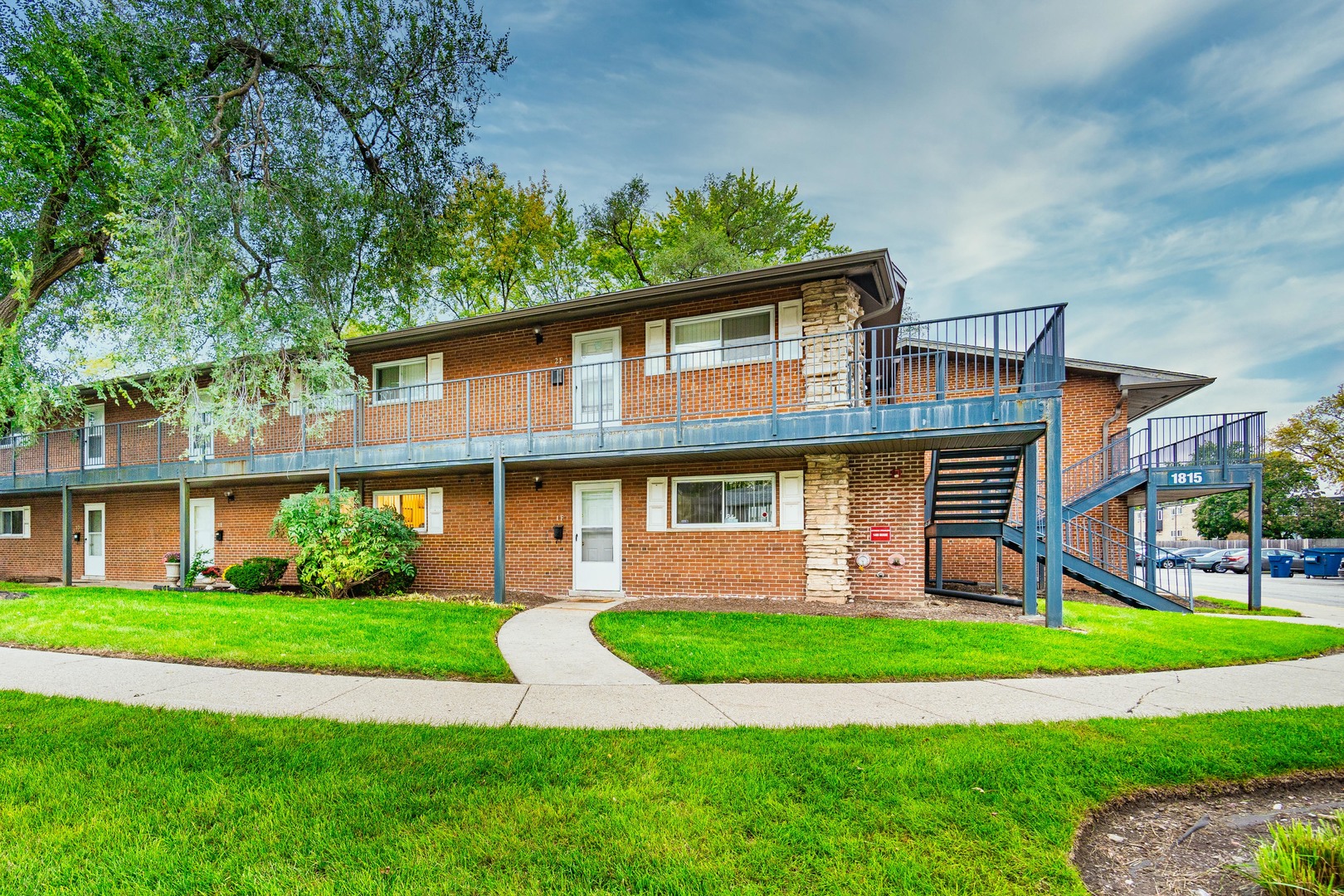 1480 Busse Road, Unit 1D Mount Prospect, IL 60056 - Photo 1 of 34 a front view of a house with a yard