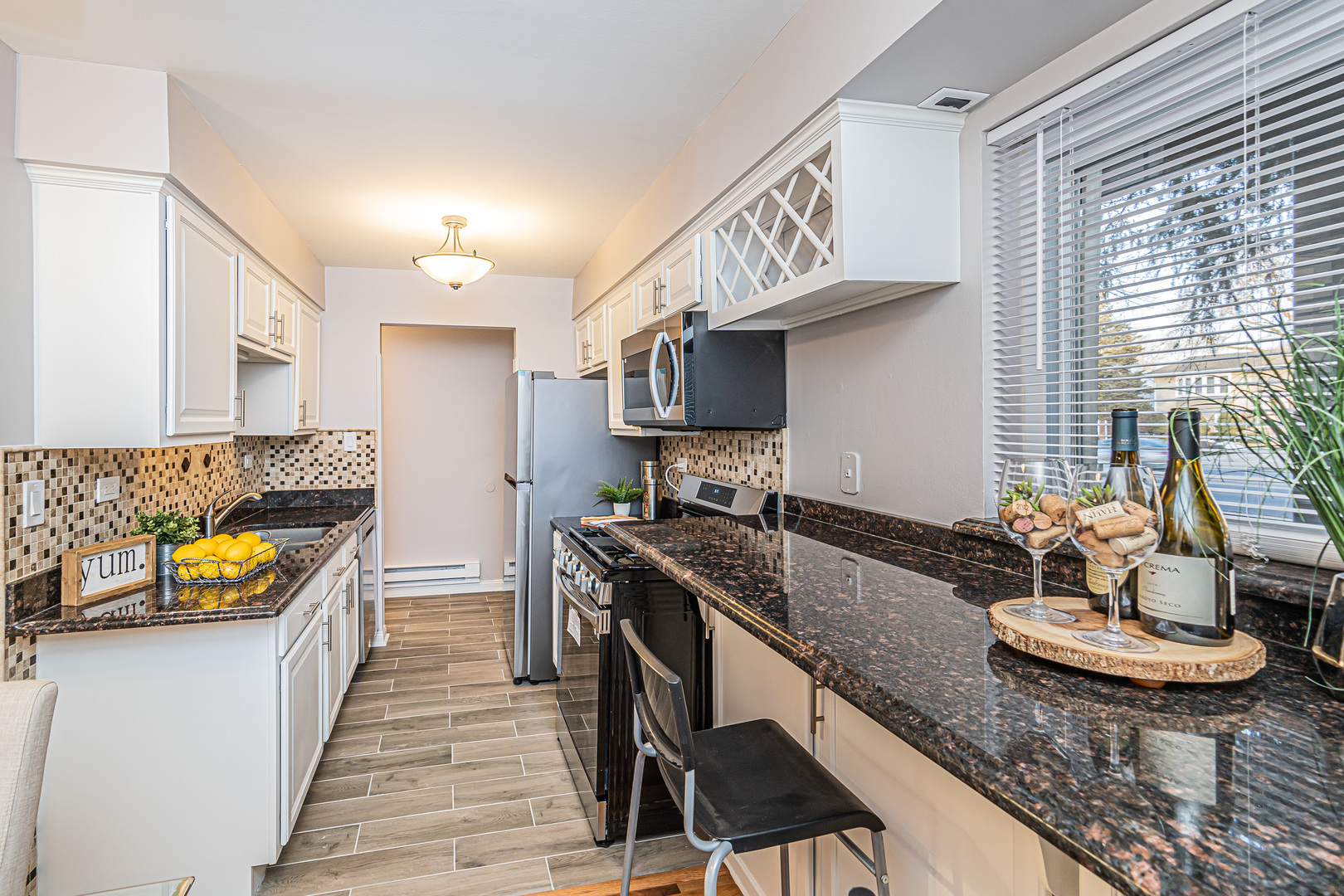 1480 Busse Road, Unit 1D Mount Prospect, IL 60056 - Photo 11 of 34 a kitchen with granite countertop lots of counter top space and stainless steel appliances