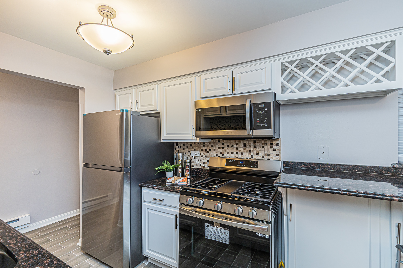 1480 Busse Road, Unit 1D Mount Prospect, IL 60056 - Photo 14 of 34 a kitchen with stainless steel appliances granite countertop a refrigerator and a stove top oven