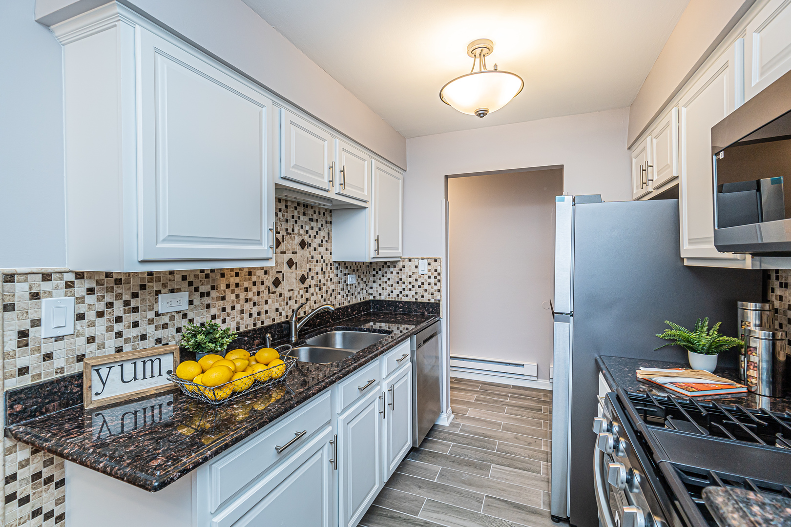 1480 Busse Road, Unit 1D Mount Prospect, IL 60056 - Photo 8 of 34 a kitchen with a sink and cabinets