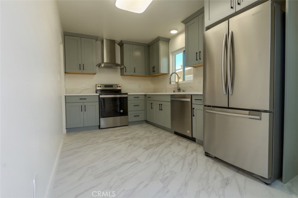 17425 Nauset Court Carson, CA 90746 - Photo 5 of 23 a kitchen with stainless steel appliances granite countertop a refrigerator a sink and white cabinets