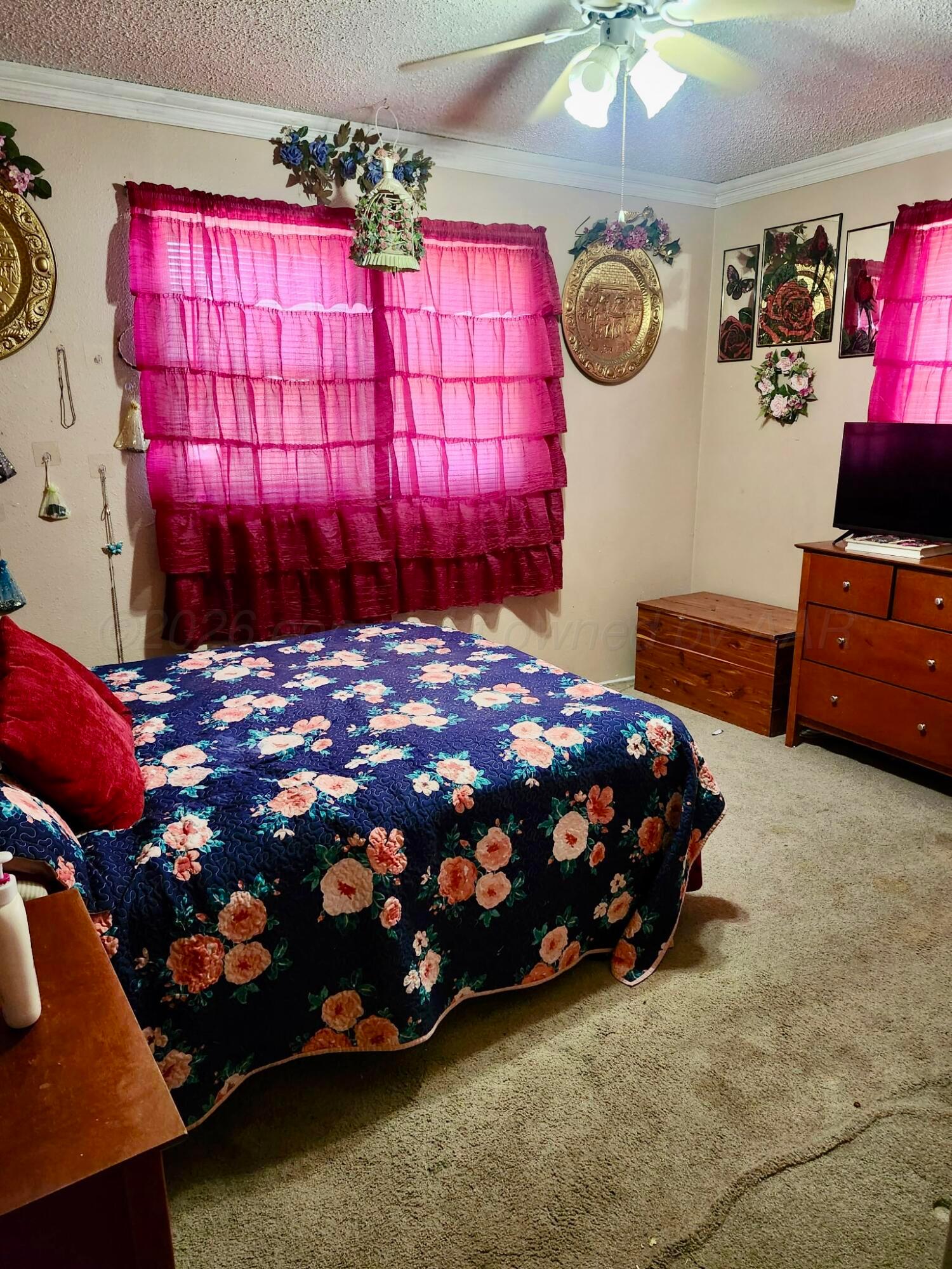 4404 South Fannin Street Amarillo, TX 79110 - Photo 11 of 13 a bedroom with a bed a dresser and a window