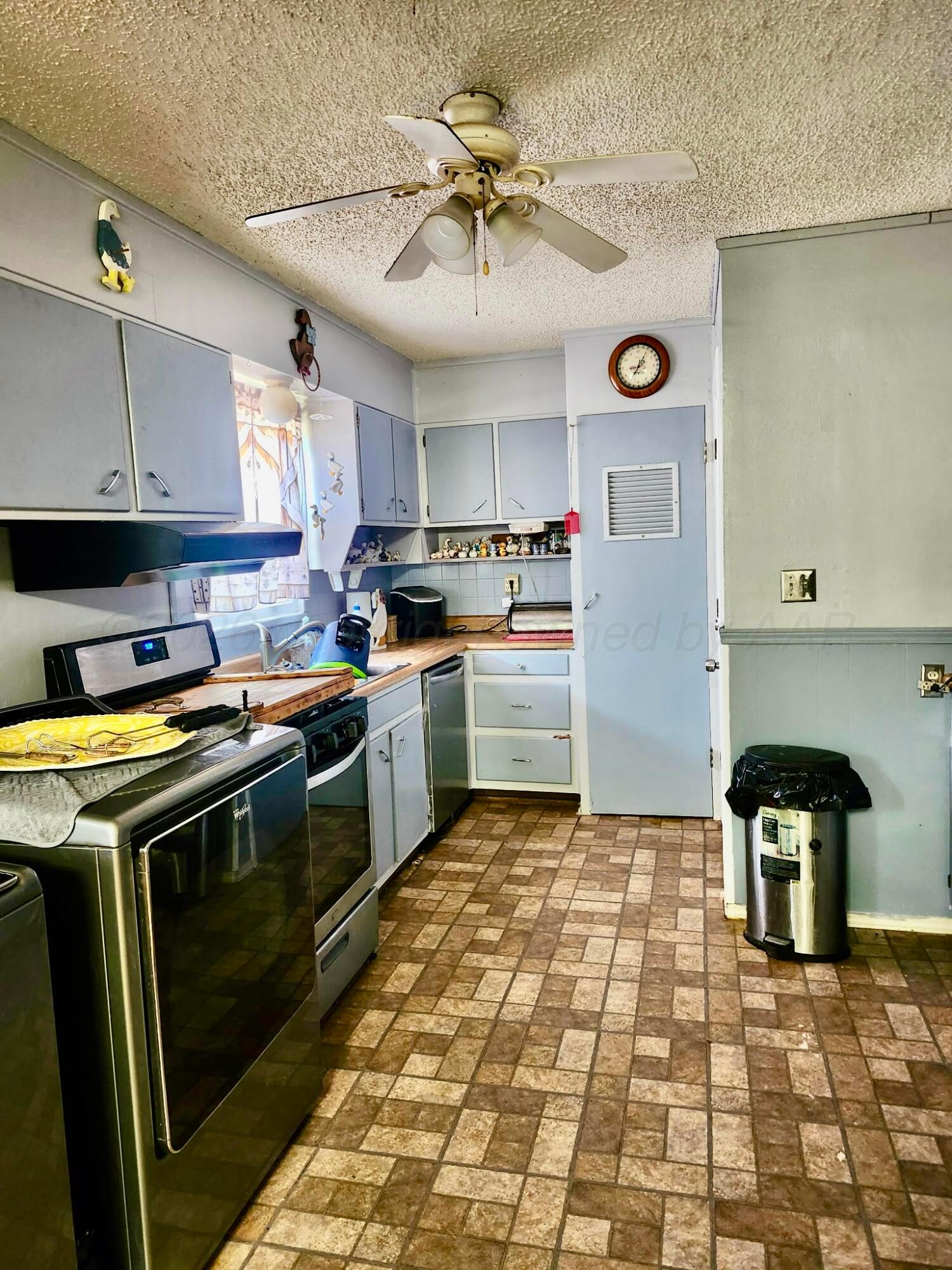 4404 South Fannin Street Amarillo, TX 79110 - Photo 5 of 13 a kitchen with a stove a sink and a refrigerator