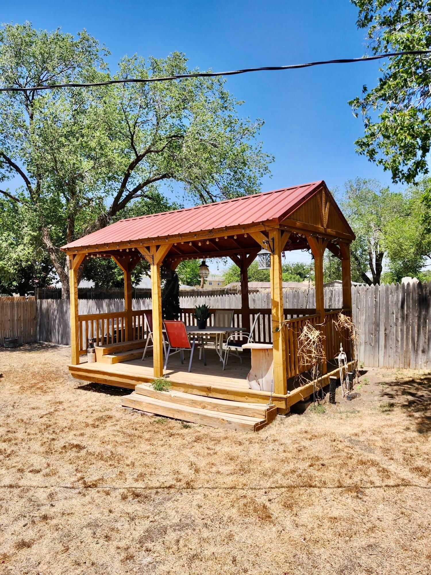 4404 South Fannin Street Amarillo, TX 79110 - Photo 7 of 13 a view of a patio with a table and chairs under an umbrella