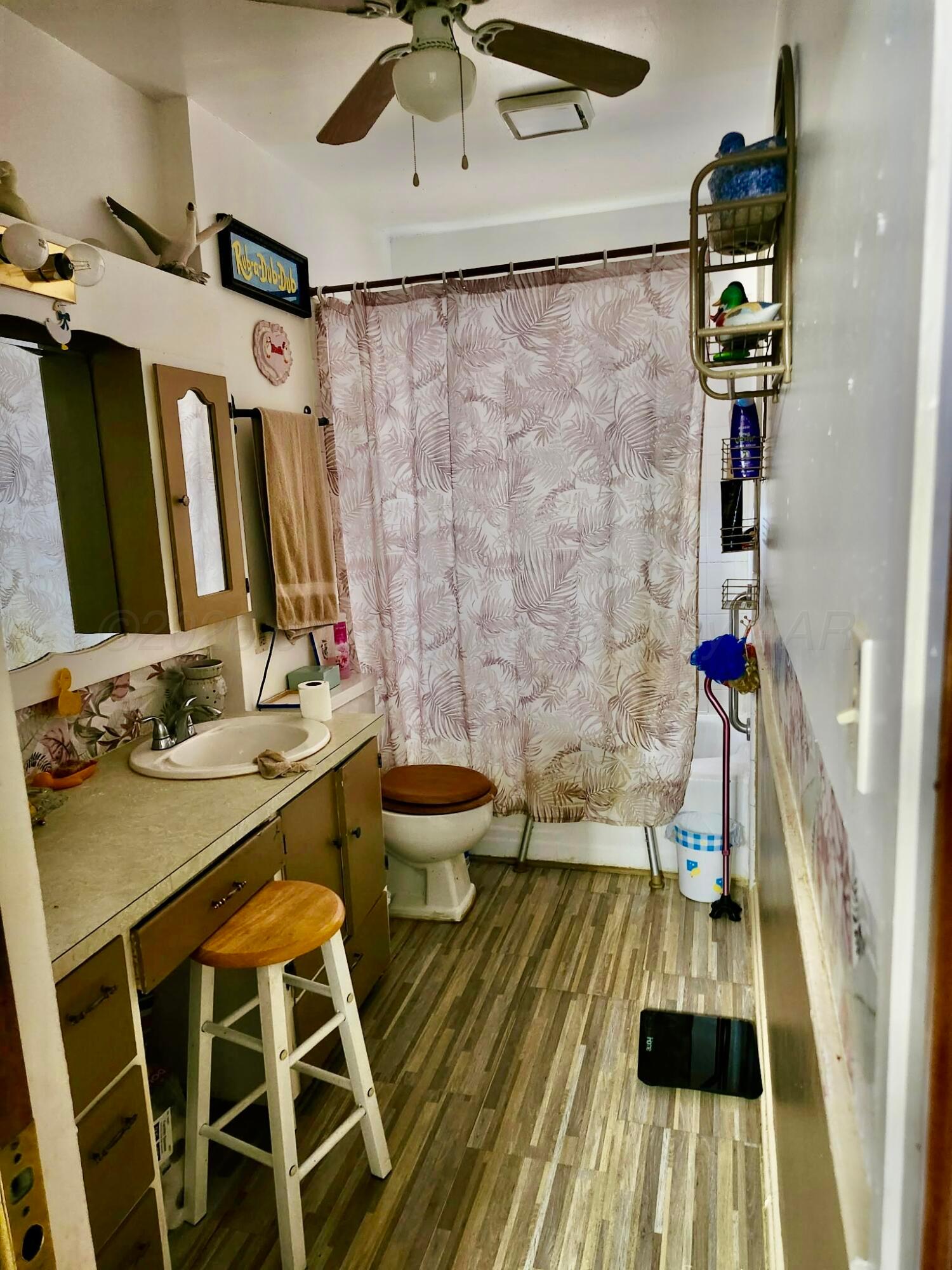 4404 South Fannin Street Amarillo, TX 79110 - Photo 10 of 13 a bathroom with a sink and a mirror