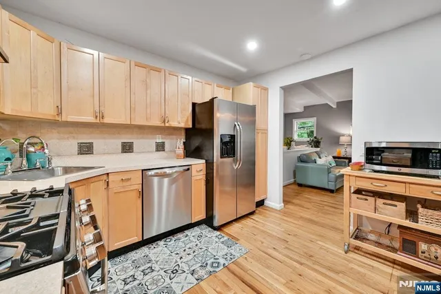 a kitchen with stainless steel appliances granite countertop a refrigerator sink and cabinets