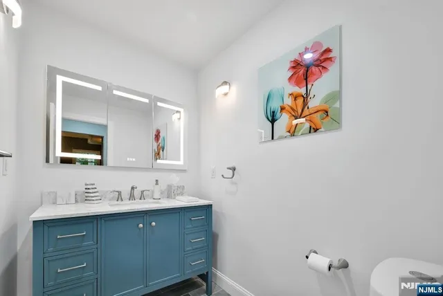 a bathroom with a sink mirror and vanity