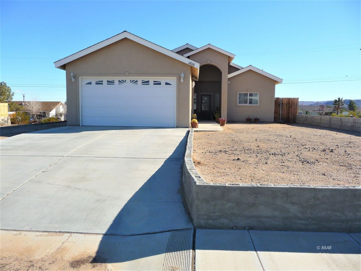 1616 South McCall Street Ridgecrest, CA 93555 - Photo 1 of 1 a view of a house with a wooden fence
