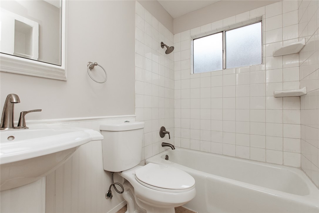 1012 Milford Way Austin, TX 78745 - Photo 13 of 21 a bathroom with a toilet a sink a mirror and bathtub