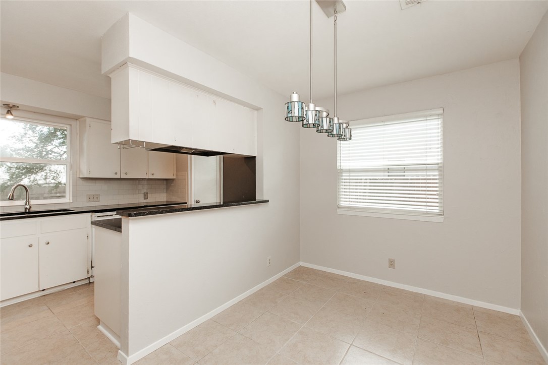 1012 Milford Way Austin, TX 78745 - Photo 3 of 21 a kitchen with stainless steel appliances granite countertop a sink and a white cabinets
