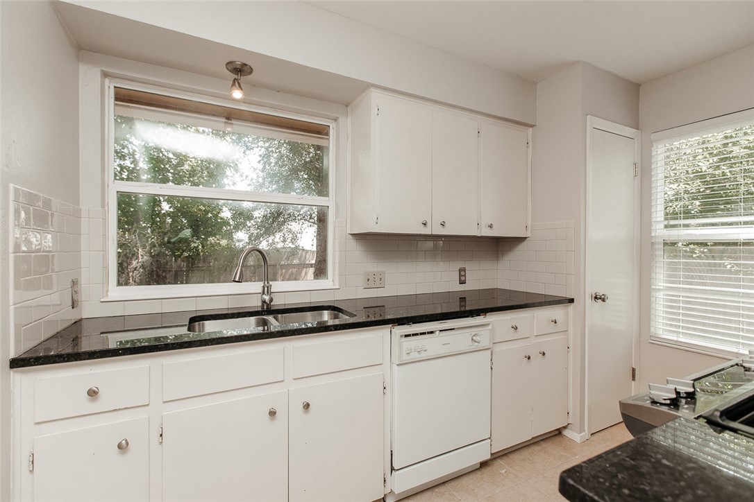 1012 Milford Way Austin, TX 78745 - Photo 6 of 21 a kitchen with stainless steel appliances white cabinets and a window