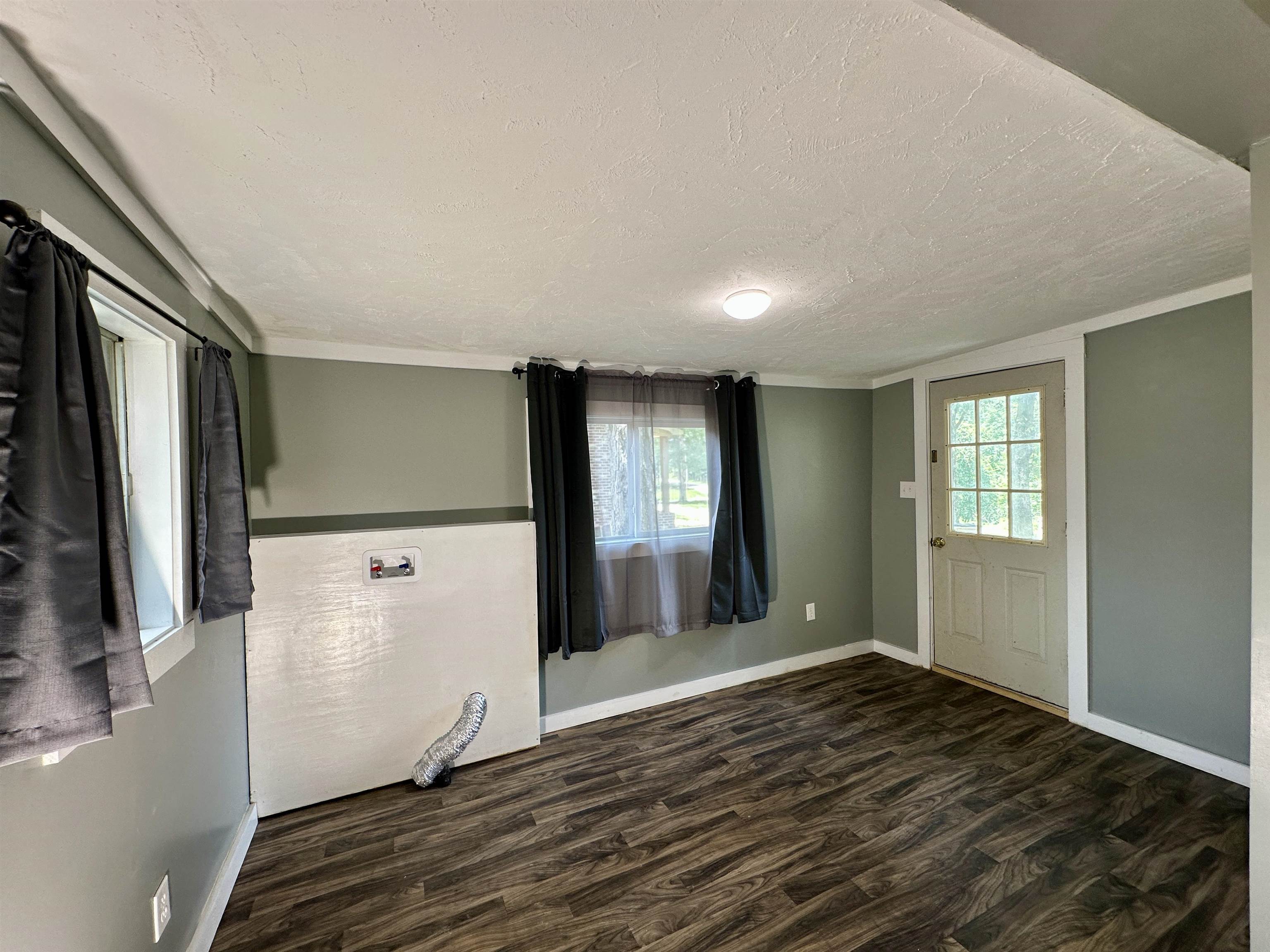 2505 Pittman Road Somerville, TN 38068 - Photo 9 of 23 Interior space featuring wood-finish flooring, two windows, and a multi-pane door