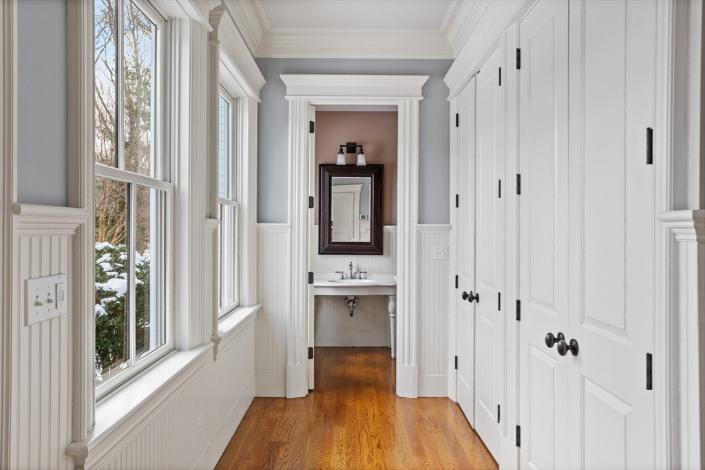 23 Burroughs Road Lexington, MA 02420 - Photo 23 of 27 a view of a hallway with wooden floor and closet area