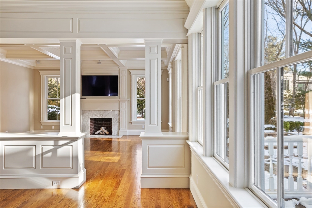 23 Burroughs Road Lexington, MA 02420 - Photo 9 of 27 a living room with fireplace and a flat screen tv