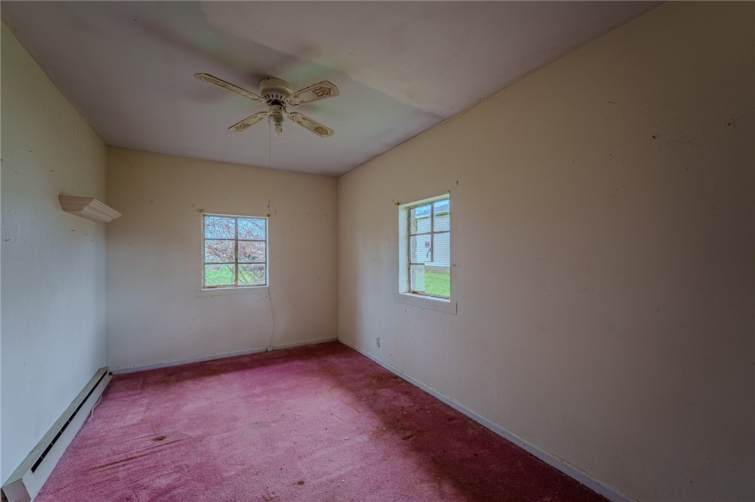 5839 Shaker Road Franklin, OH 45005 - Photo 7 of 18 This cozy bedroom features bright windows, a ceiling fan, and ample space for rest and relaxation.