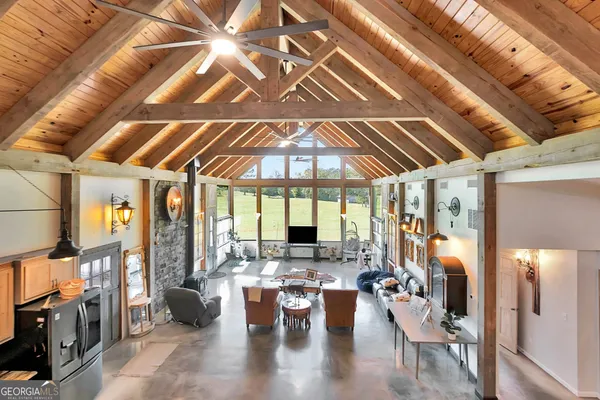 a kitchen with stainless steel appliances granite countertop a stove a sink dishwasher a refrigerator and cabinets with wooden floor