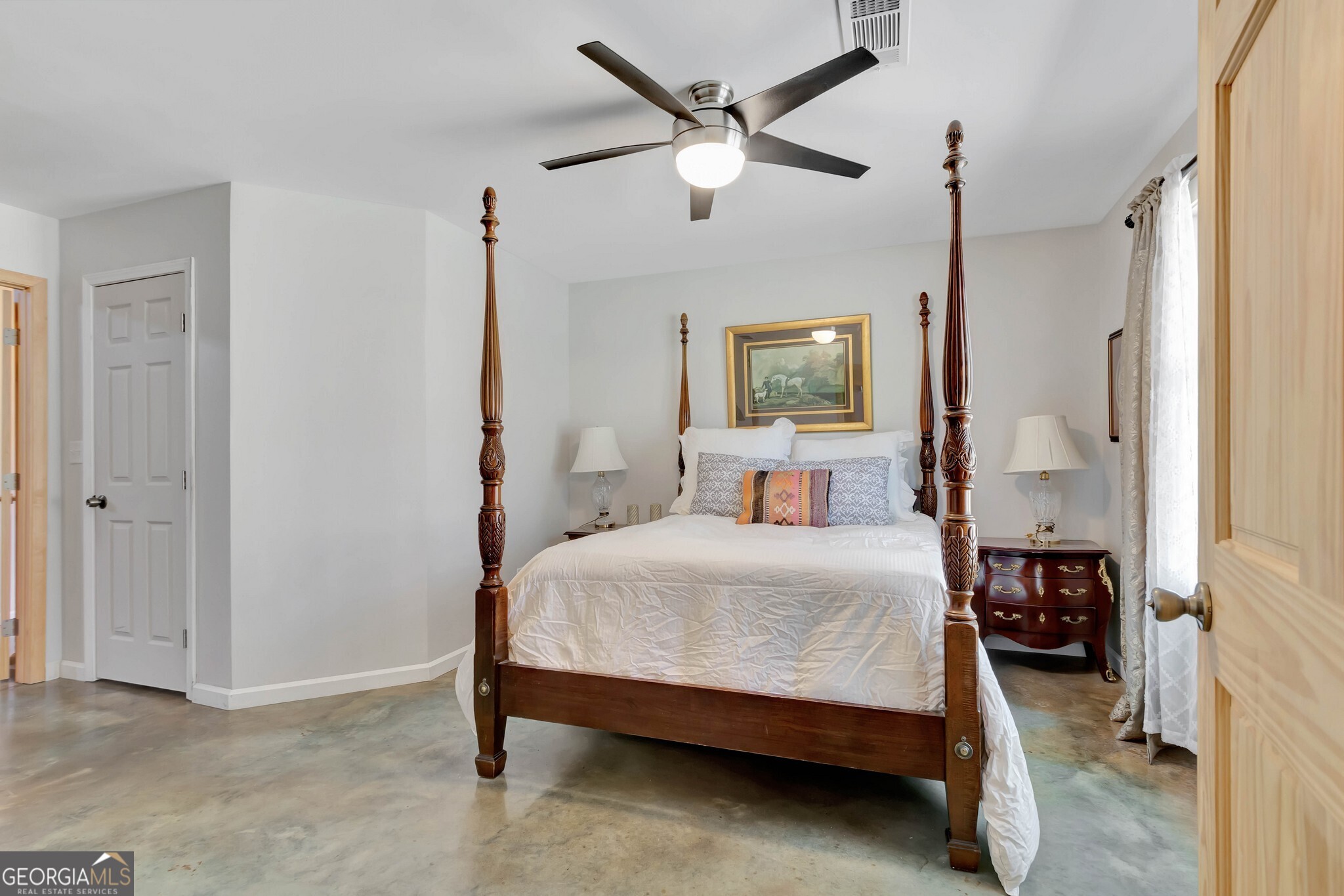 860 North Walker's Mill Road Griffin, GA 30223 - Photo 33 of 116 a bedroom with a bed a window and a chandelier
