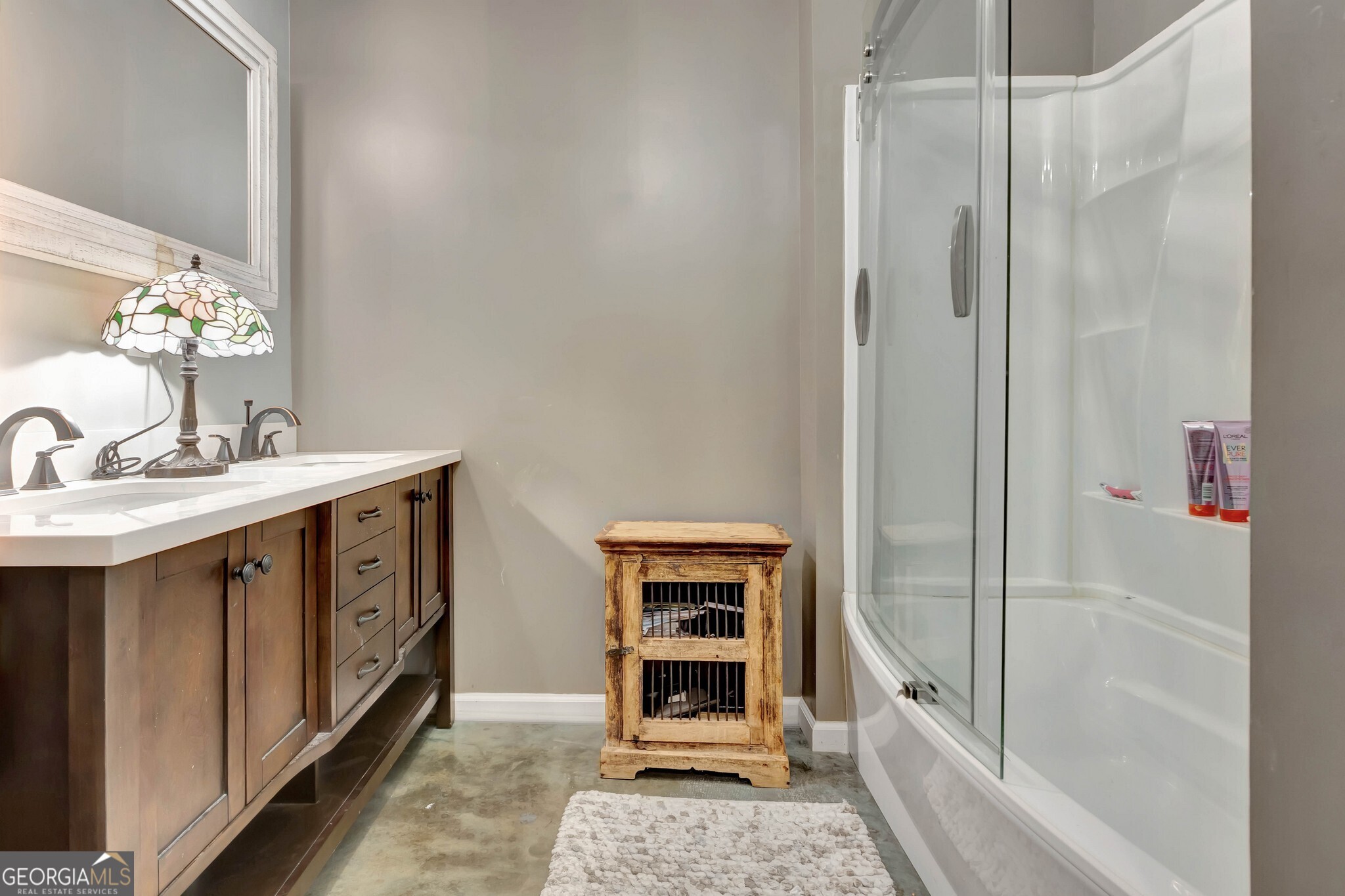 860 North Walker's Mill Road Griffin, GA 30223 - Photo 39 of 116 a bathroom with a sink a mirror and a shower