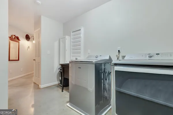 a view of a tree in a backyard of a house