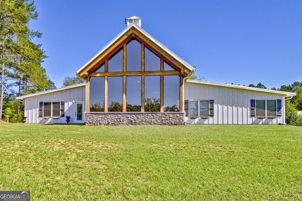 a living room with furniture tv and a large window