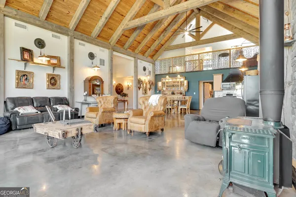 a kitchen with stainless steel appliances granite countertop a refrigerator a sink a stove and oven