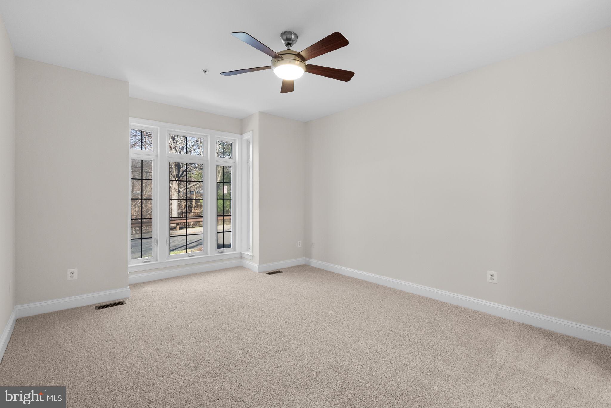 2788 Westminster Road Ellicott City, MD 21043 - Photo 23 of 75 an empty room with windows and ceiling fan