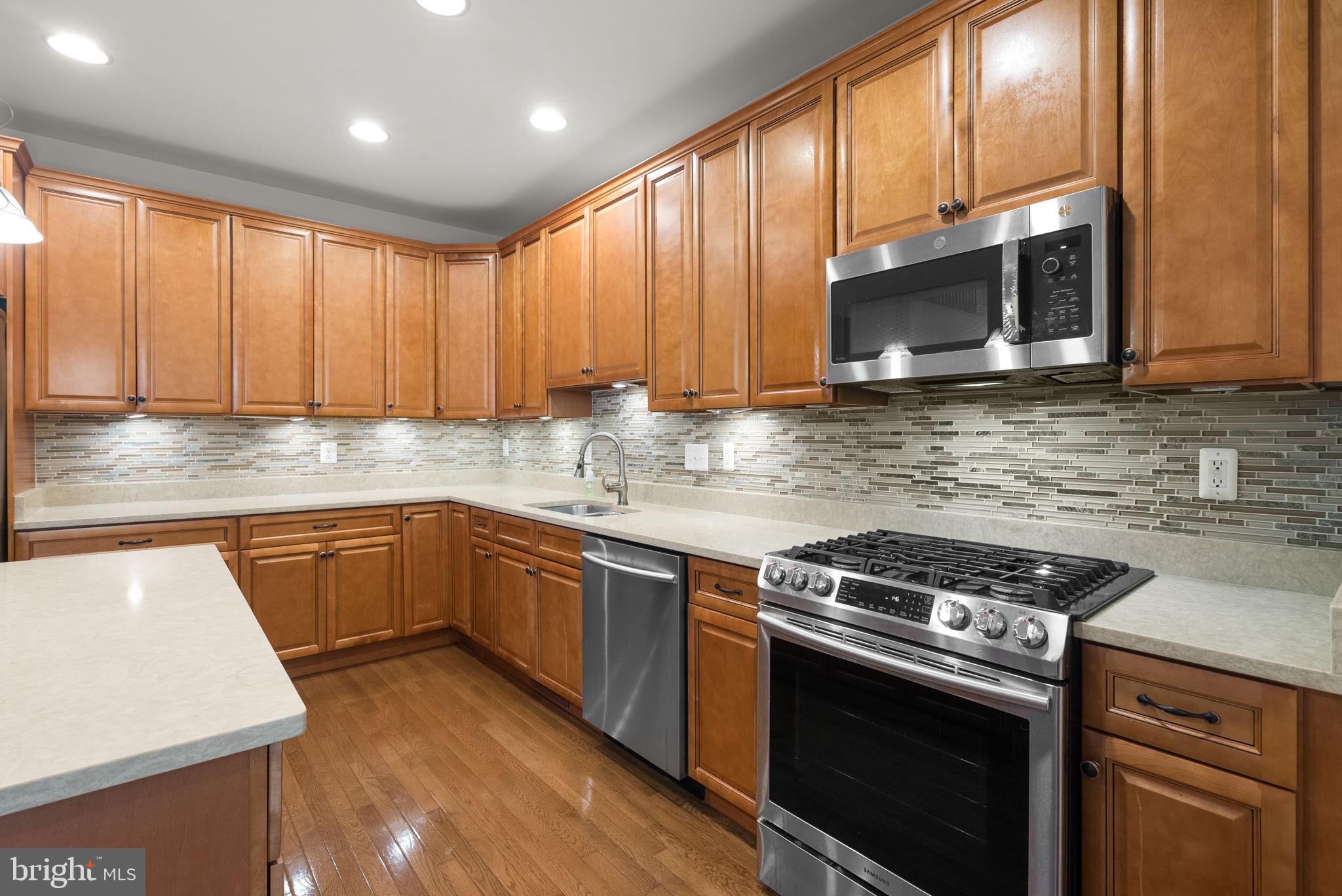 2788 Westminster Road Ellicott City, MD 21043 - Photo 5 of 75 a kitchen with stainless steel appliances granite countertop wooden cabinets stove top oven and sink