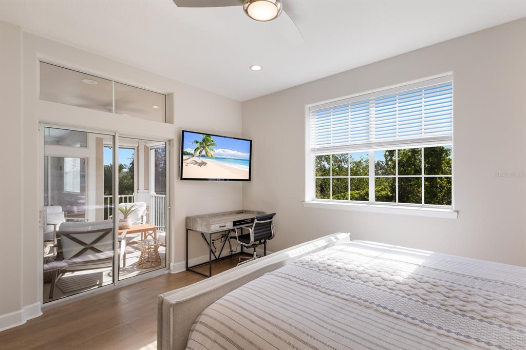 8035 St Simons Street, Unit 8035 University Park, FL 34201 - Photo 17 of 33 a bedroom with a bed and a large window with chair