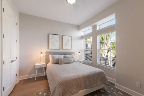 a bedroom with a large bed and a window